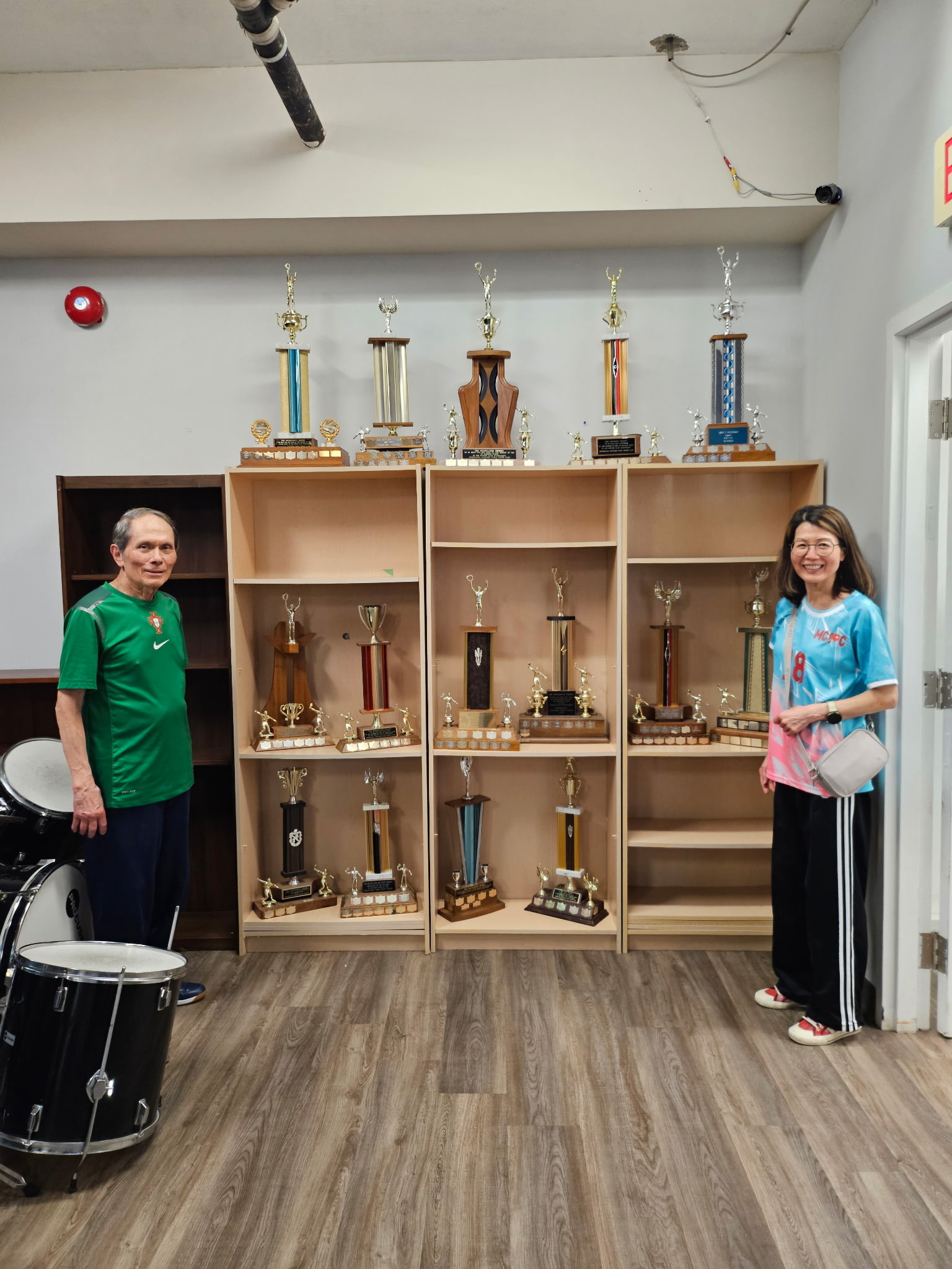 Mississauga Rattlers members standing beside the club’s collection of annual table tennis trophies